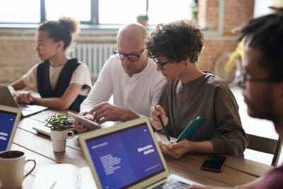 group of people working together on devices